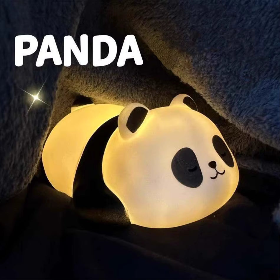 Panda-shaped night light emitting a warm glow on a dark background
